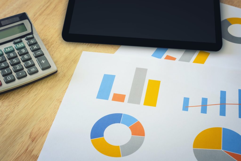 financial chart with calculator and digital tablet
